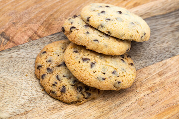 Fresh homemade chocolate chip cookie on wood table .