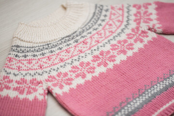 Knitted children's sweater on a white background
