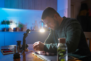 Technician holding screwdriver and repairing laptop at home