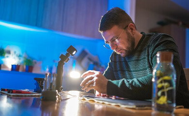 Technician with eyeglasses repairing laptop at home