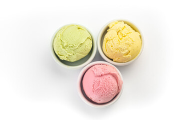 Different ice cream balls in a bowl, isolated on a white background