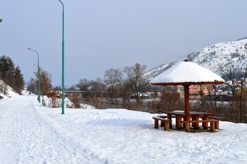 wooden summer house under the snow in winter
