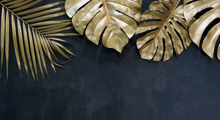 Collection of tropical leaves in gold color on black space background.Abstract leaf decoration design.