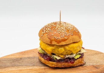 Fresh delicious burger, on wood table.