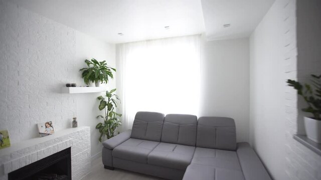 Dining and living room of new house. Big gray sofa in vacation home or holiday villa. apartment after renovation