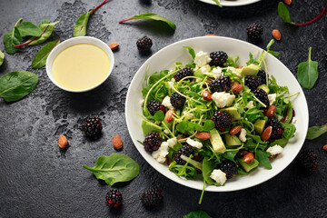 Blackberry salad with greens, almond nuts, feta, avocado and feta cheese