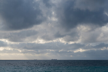 Lonely ship in the middle of the sea with heavy clouds