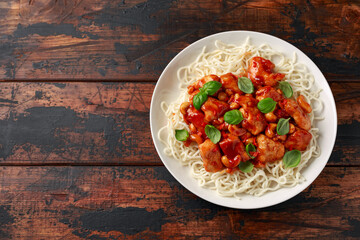 Sweet Chilli Chicken with noodles on wooden table. asian food