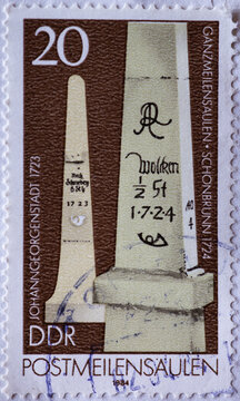 GERMANY, DDR - CIRCA 1984 : a postage stamp from Germany, GDR showing a historic post mile pillar: border mile pillar Johanngeorgenstadt (1723) and Schönbrunn (1724)