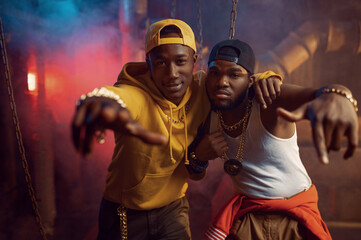 Two young rappers, breakdancing in studio