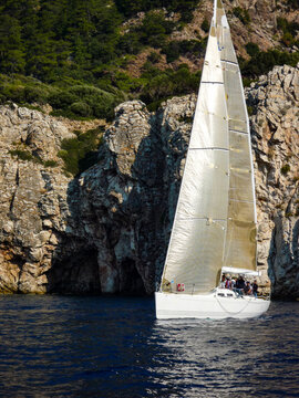 sail boat yacht in race regatta with mountain background