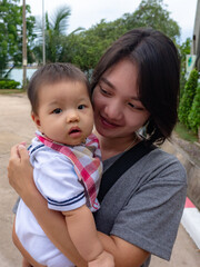 Portrait of an asian woman holding a baby