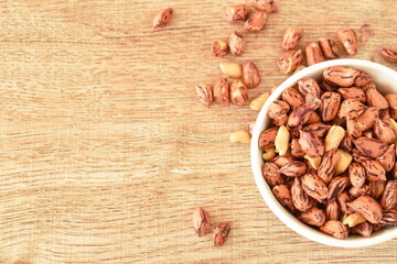 baked salty tiger stripe peel peanut in cup on table