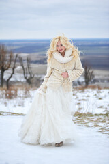 Fototapeta na wymiar Beautiful bride near old castle on winter wedding day