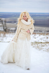 Beautiful bride near old castle on winter day wedding 