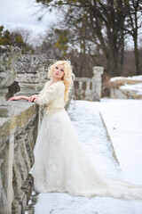 Fototapeta na wymiar Beautiful bride near old castle on winter day wedding 
