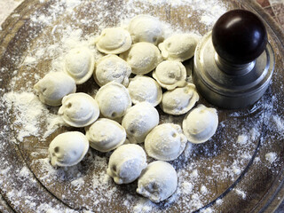 Traditional pelmeni or dumpling at cutting board. Homemade preparation food.