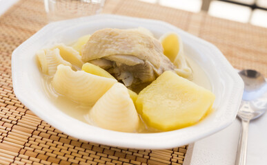chicken broth soup with chicken, potatoes, and pasta shells