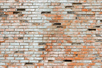 old crumbling brick wall made of ceramic red brick