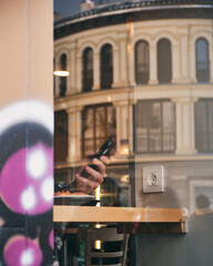 Man sitting in cafe and using his mobile phone