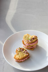 Holiday cookies in the shape of a heart, with cottage cheese cream and pistachios