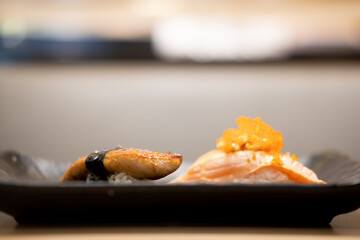 Salmon sushi and foie gras sushi. Fusion Japanese.