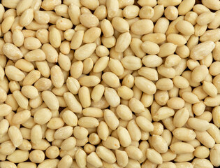 Top view of peeled peanuts as background, texture.