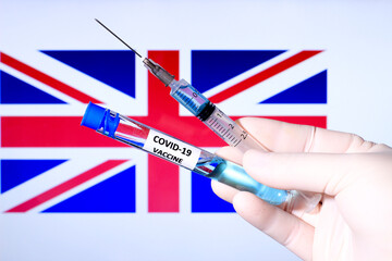 Hand holding syringe with covid vaccine