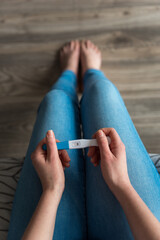 The young woman found out that she managed to get pregnant after a long time, she is happy. - obrazy, fototapety, plakaty