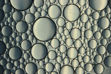 abstract macro background of oil circles floating over water surface .