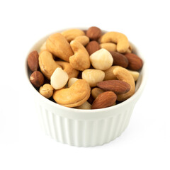 Obraz na płótnie Canvas Nuts in circle shaped ceramic bowls isolated on white background. Various nuts (almonds, macadamia, cashew, peanuts). Mix nut healthy ingredients food.