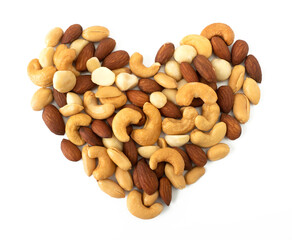 Nuts in shape of Heart isolated on white background. Various nuts (almonds, macadamia, cashew, peanuts). Mix nut for romantic feelings and healthy ingredients food.