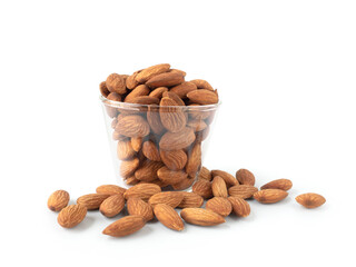 Organic almonds in glass bowl and heap almonds isolated on white background for almond nuts can improve health concept.