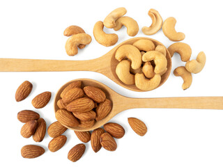 Organic almonds and cashew nuts in wooden spoon and heap almonds and cashew isolated  top view on...