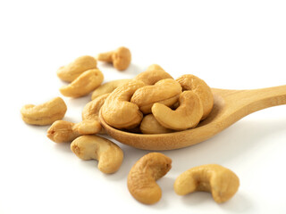 Organic cashew nuts in wooden spoon and heap almonds isolated on white background for almond nuts can improve health concept.