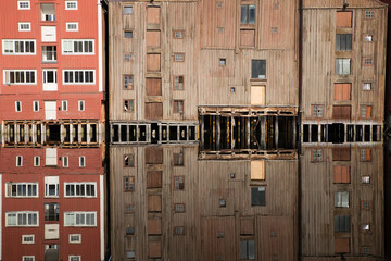 Reflections of traditional storehouses on River Nidelva in Trondheim, Norway