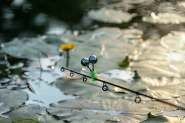 Bell on a fishing rod above water