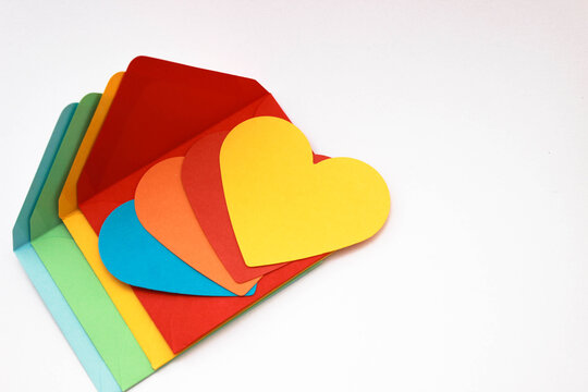 colorful heart-shaped papers for bisexual love messages or for gay chat sites concept photo on colorful envelopes. copy space for your text. 