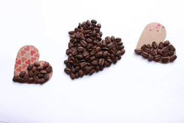 For valentines day or for lgbt day; heart shape made from coffee beans, love and coffee themed concept background photo isolated on white background. Top view, copy space for your text.