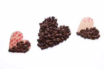 Top view, heart shape made from coffee beans, love and coffee themed concept background photo isolated on white background. For valentines day or pride day for gay, lesbian love. Copy space text.