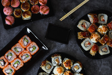 Fresh sushi rolls set on gark background