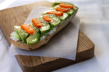 Healthy and nutritious breakfast of wholegrain bread avocado cheese and boiled carrots with egg