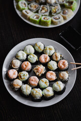 Fresh sushi rolls set on gark background
