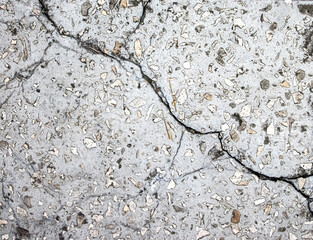 A crack in a stone slab. Broken footpath.