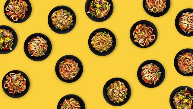 seamless looping animation with many different colorful wok food on black plates wiggle on a yellow background. chinese cooking with meat, vegetables and noodles