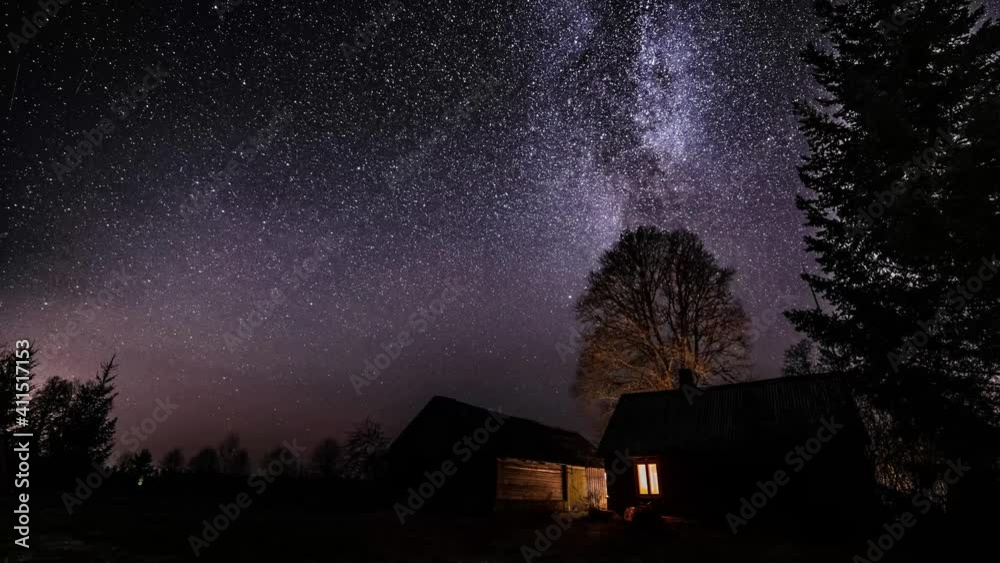 Wall mural milky way timelapse with stars in clear summer night. old barn house. country side. timelapse footag