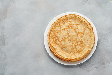 Crepes, thin pancakes on gray plate. Marble background. Copy space. Mock up. Top view.