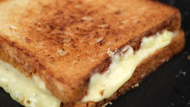 sandwich with cheese on pan. grilled cheese sandwich close up