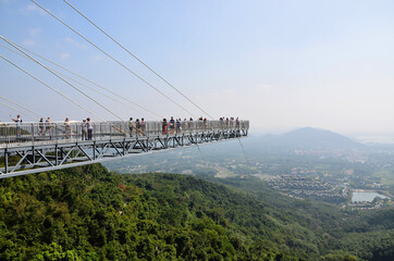 Group of tourists on a glass bridge in Yanoda Park