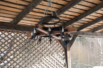 a black antique chandelier with candles hanging on a chain. Lamps
